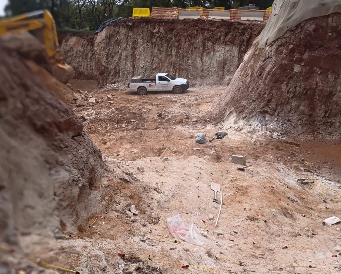 Active Blasting crew assessing blasted rock face on a restricted blasting project
