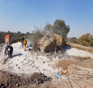 Drilling work around exposed rock